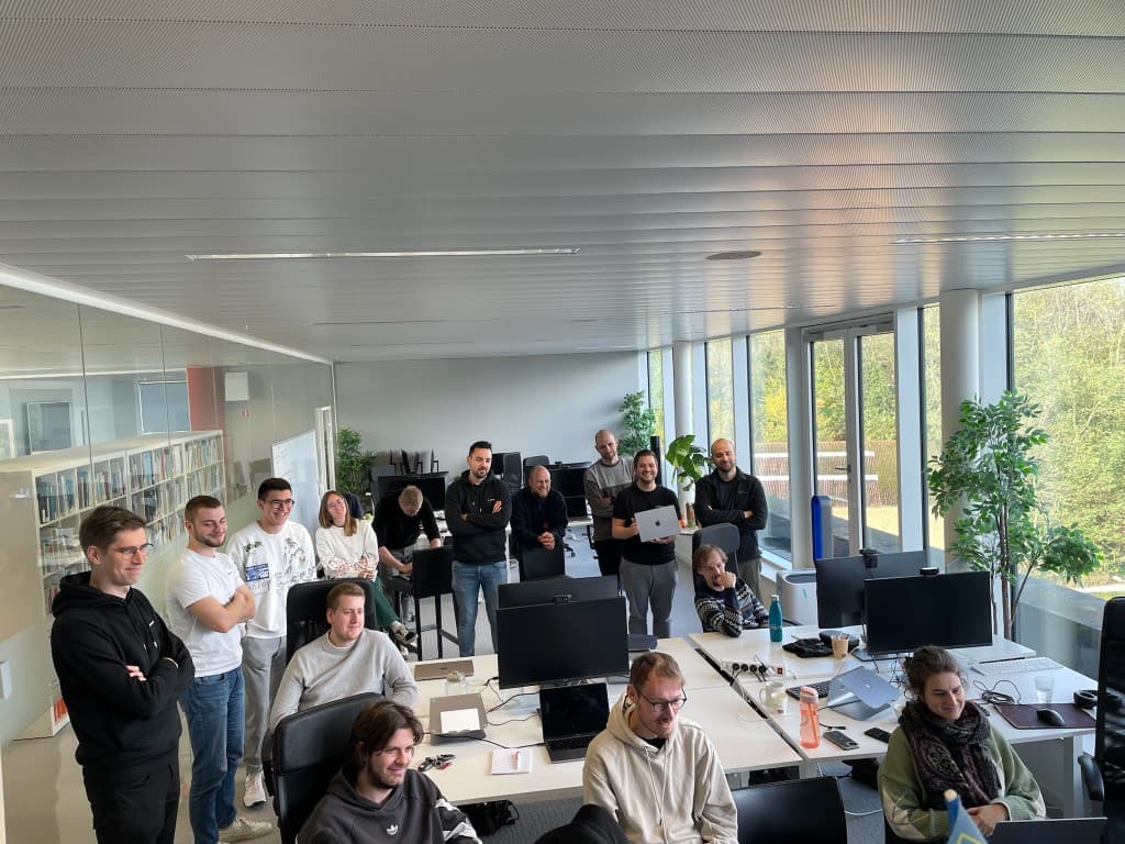 Group standing in the office during a team briefing.