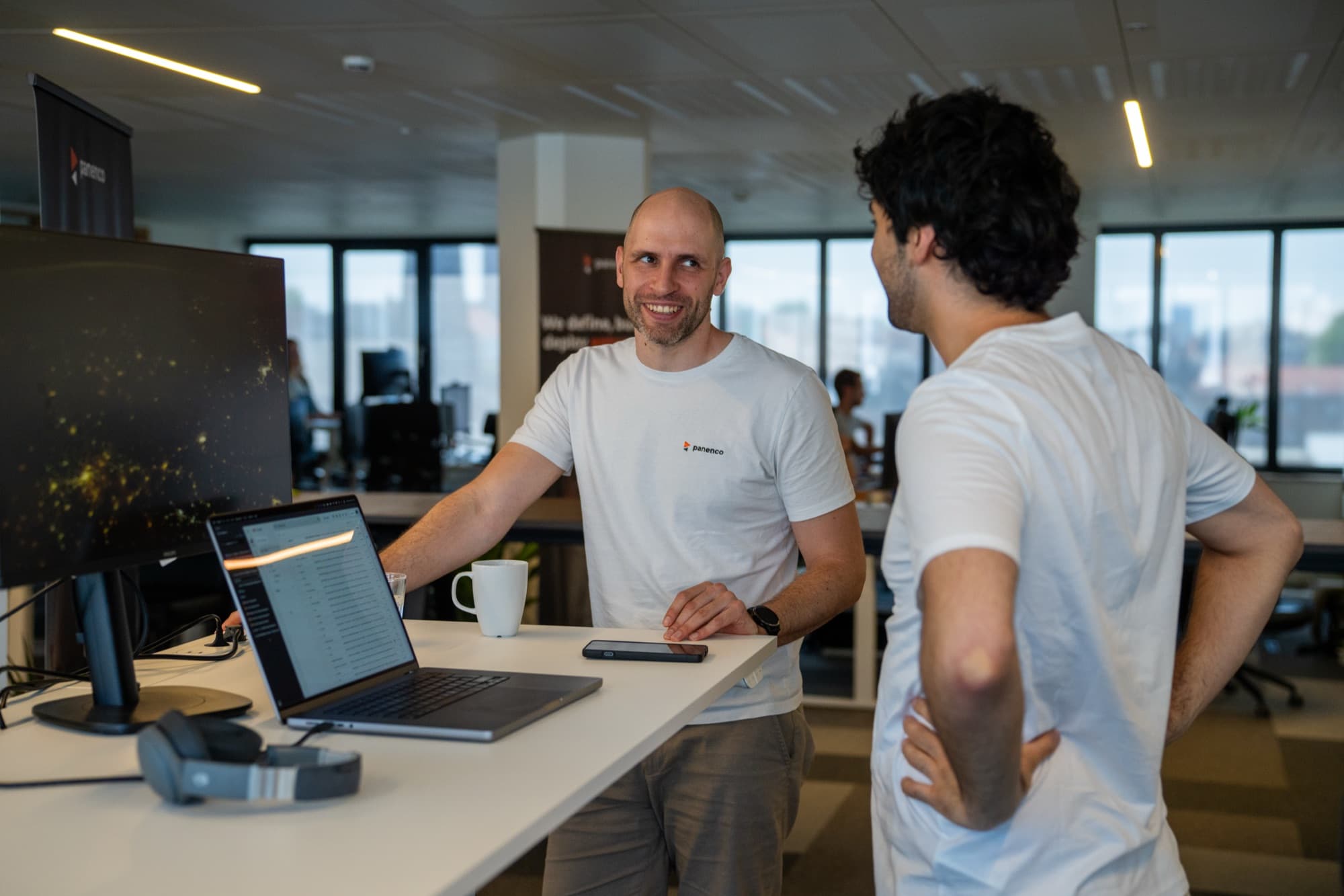 Panenco team collaborating in the open office